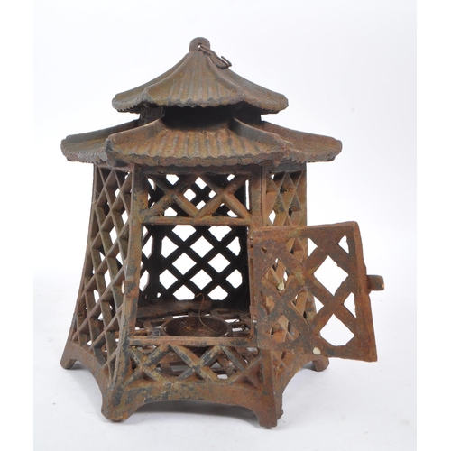 312 - A 19th century cast iron Japanese pagoda candle holder / lantern. Comprising of a two tiered hexagon... 