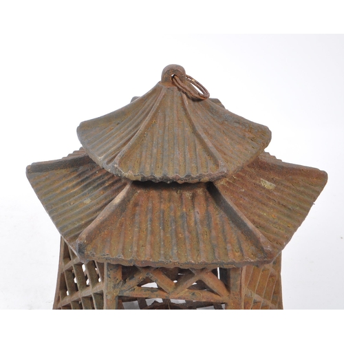 312 - A 19th century cast iron Japanese pagoda candle holder / lantern. Comprising of a two tiered hexagon... 