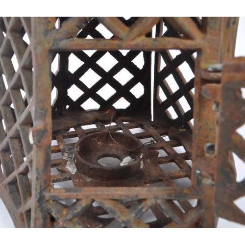 312 - A 19th century cast iron Japanese pagoda candle holder / lantern. Comprising of a two tiered hexagon... 