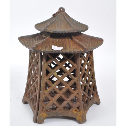 312 - A 19th century cast iron Japanese pagoda candle holder / lantern. Comprising of a two tiered hexagon... 