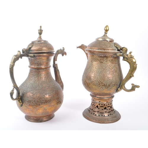 314 - Two early 20th century Indian / Tibetan water / kettle copper and brass jugs. With embossed decorati... 