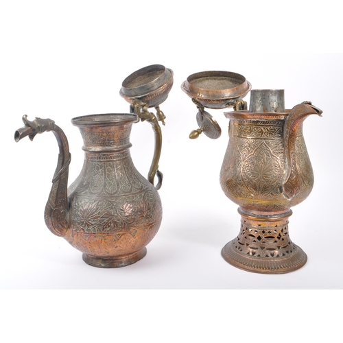 314 - Two early 20th century Indian / Tibetan water / kettle copper and brass jugs. With embossed decorati... 