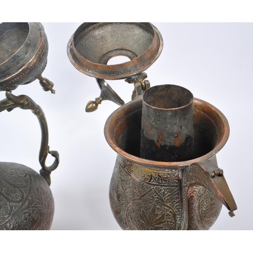 314 - Two early 20th century Indian / Tibetan water / kettle copper and brass jugs. With embossed decorati... 