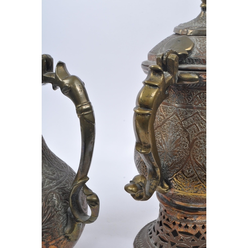 314 - Two early 20th century Indian / Tibetan water / kettle copper and brass jugs. With embossed decorati... 