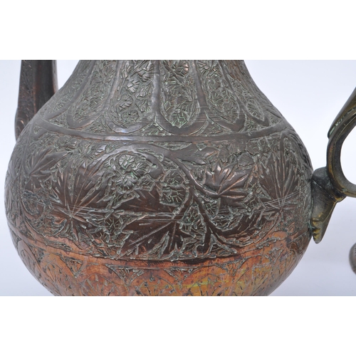 314 - Two early 20th century Indian / Tibetan water / kettle copper and brass jugs. With embossed decorati... 