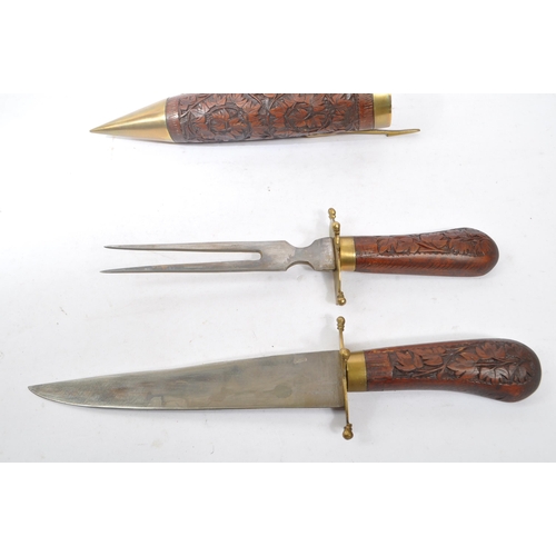 318 - A vintage Indian fish knife and fork set housed in a hand carved double scabbard with brass latch an... 