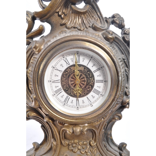 323 - A 20th Century ornate Art Nouveau style West Germany face moulded gilt metal mantel clock having flo... 