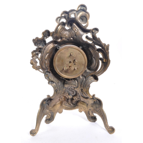 323 - A 20th Century ornate Art Nouveau style West Germany face moulded gilt metal mantel clock having flo... 