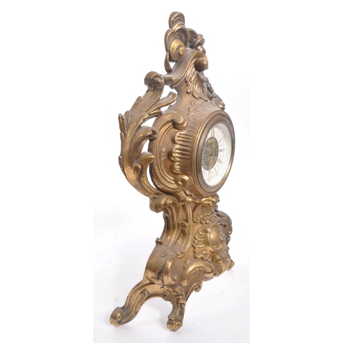 323 - A 20th Century ornate Art Nouveau style West Germany face moulded gilt metal mantel clock having flo... 