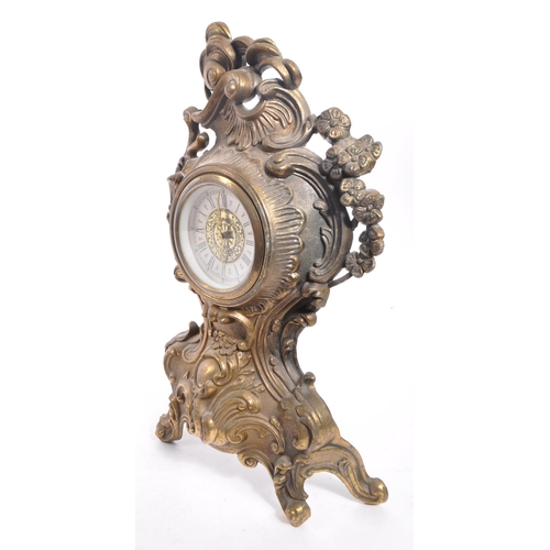 323 - A 20th Century ornate Art Nouveau style West Germany face moulded gilt metal mantel clock having flo... 