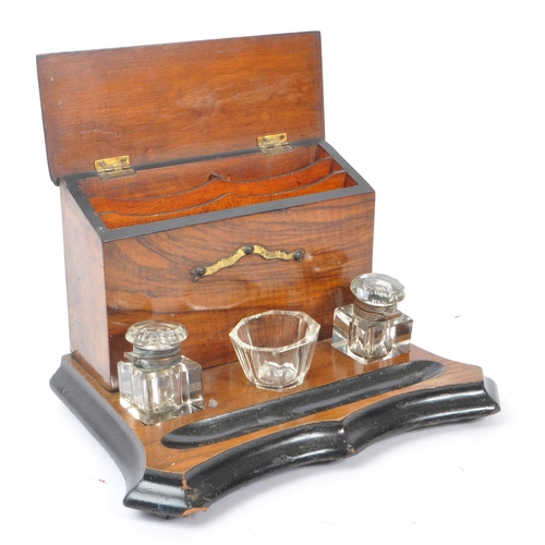 335 - A Victorian 19th century walnut desk tidy inkwell. Glass inkwells, bowls and pen tray beneath uprigh... 