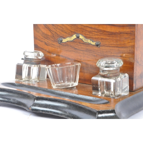 335 - A Victorian 19th century walnut desk tidy inkwell. Glass inkwells, bowls and pen tray beneath uprigh... 