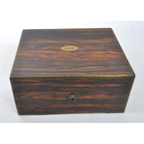 340 - A 19th century coromandel wood and brass cartouche inlaid leather ladies' vanity box. With contents ... 