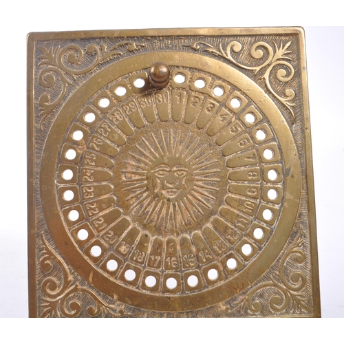 344 - A brass perpetual astrology sun wheel calendar stand of square form, having circular dial with engra... 