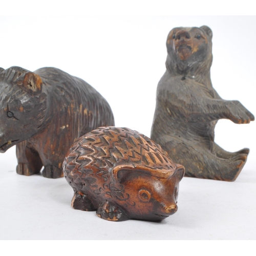 345 - Two vintage 20th Century Black Forest hand carved wooden bears, one stood on all fours, the other si... 