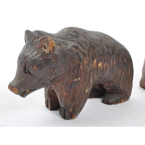 345 - Two vintage 20th Century Black Forest hand carved wooden bears, one stood on all fours, the other si... 