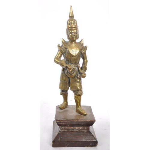 348 - A brass Nepalese warrior figure upon a stepped square wooden base, accompanied by a brass handled bo... 