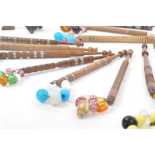 350 - A collection of 19th & 20th century carved lace bobbins to include bead adorned etc long with picks ... 