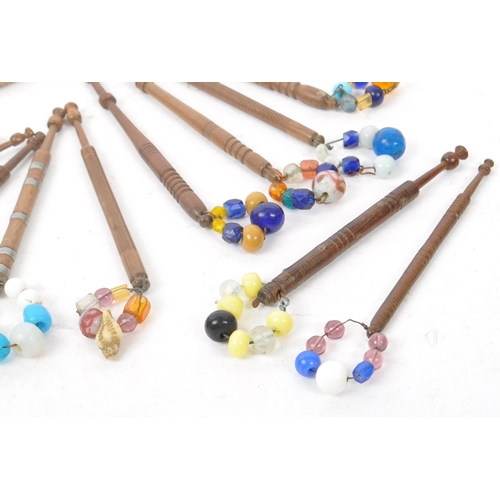 350 - A collection of 19th & 20th century carved lace bobbins to include bead adorned etc long with picks ... 