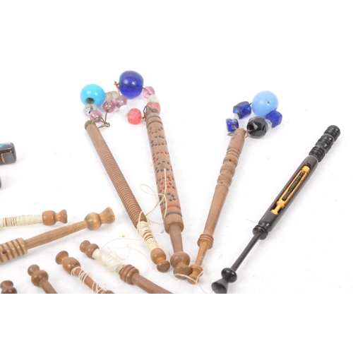 350 - A collection of 19th & 20th century carved lace bobbins to include bead adorned etc long with picks ... 