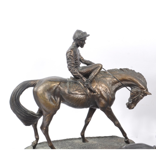 355 - A collection of 20th Century nine bronze effect figures of jockeys and racing horses upon various pl... 