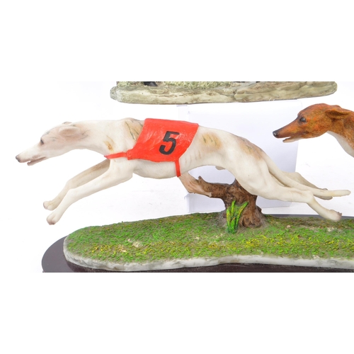 363 - The Juliana Collection - A 20th Century Juliana Collection resin figure in the form of two greyhound... 