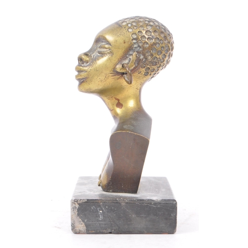 368 - A 20th Century painted African bronze bust figure depicting a woman with large hooped earrings upon ... 