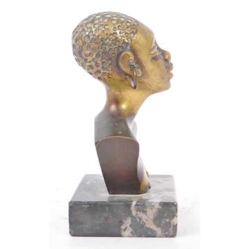 368 - A 20th Century painted African bronze bust figure depicting a woman with large hooped earrings upon ... 