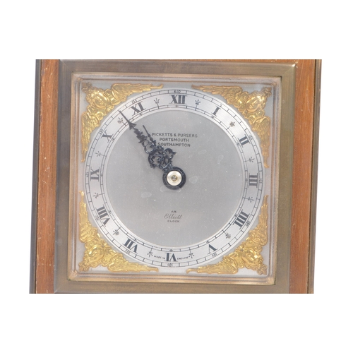 398 - Elliott - A 20th century Elliott of London oak cased mantle clock. The clock raised on brass bun fee... 