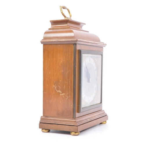 398 - Elliott - A 20th century Elliott of London oak cased mantle clock. The clock raised on brass bun fee... 