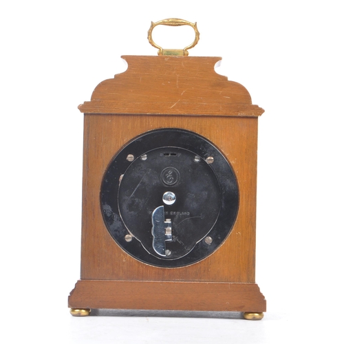 398 - Elliott - A 20th century Elliott of London oak cased mantle clock. The clock raised on brass bun fee... 