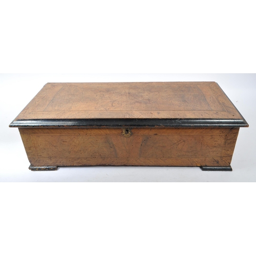 401 - A late 19th century Swiss walnut cross banded cylinder music box. Rectangular form with chamfered ed... 