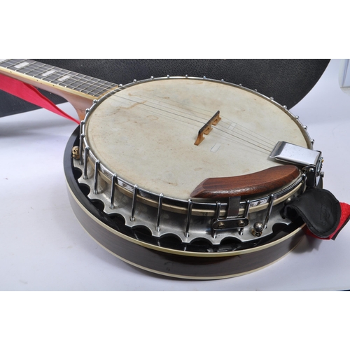 430 - A late 20th century five string closed back banjo. The banjo having a mahogany closed back, with sta... 