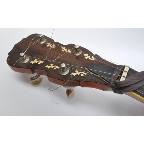 430 - A late 20th century five string closed back banjo. The banjo having a mahogany closed back, with sta... 