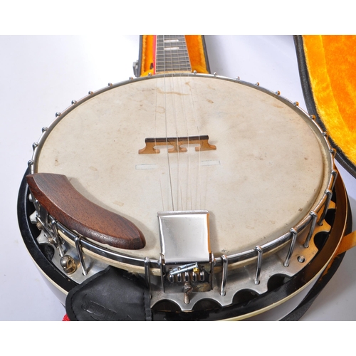 430 - A late 20th century five string closed back banjo. The banjo having a mahogany closed back, with sta... 