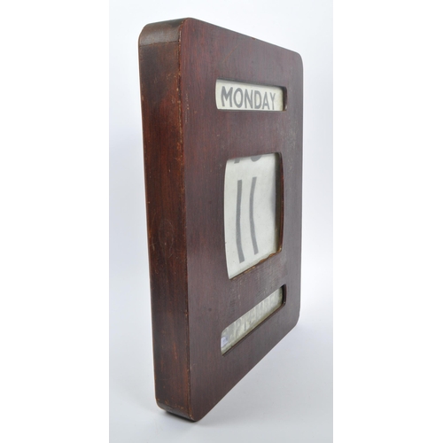 443 - A large early / mid Century wooden wall mounted perpetual calendar of square form, having windows fo... 