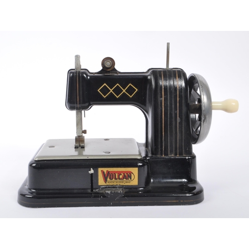 445 - Volcan - Mid 20th century toy tin sewing machine. Made in England with label to side. Black colour w... 