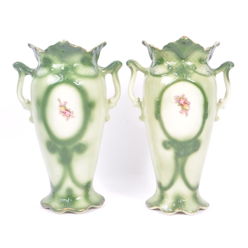 51 - A pair of 19th century amphora ceramic pottery vases. With foliate shaped rims, twin handle, green c... 