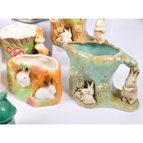 58 - Sylvac - A collection of vintage 20th century ceramic pottery rabbit spill vases. In the form of tre... 