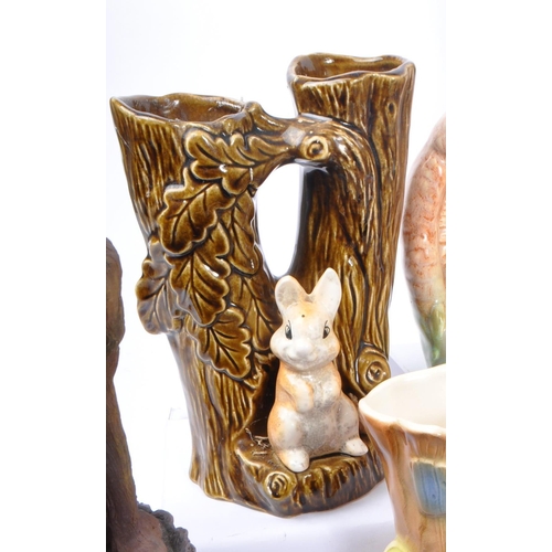 58 - Sylvac - A collection of vintage 20th century ceramic pottery rabbit spill vases. In the form of tre... 