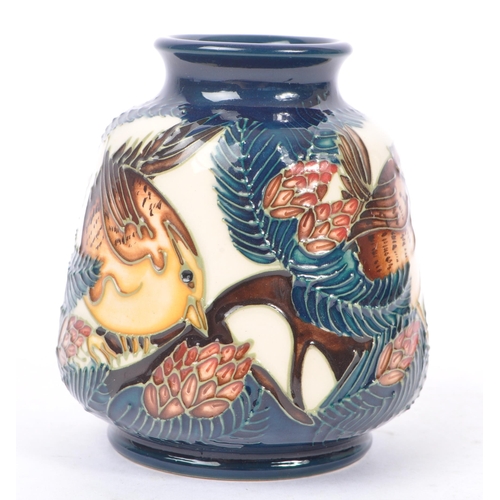 6 - Moorcroft - A china porcelain Moorcroft Pottery small vase in bird and pine tree pattern against cre... 