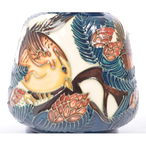 6 - Moorcroft - A china porcelain Moorcroft Pottery small vase in bird and pine tree pattern against cre... 