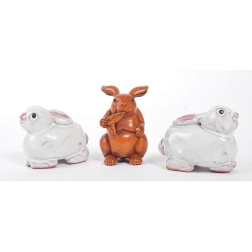 60 - A vintage 20th century Netsuke rabbits sculpture / figures. To include two ceramic examples, and a w... 