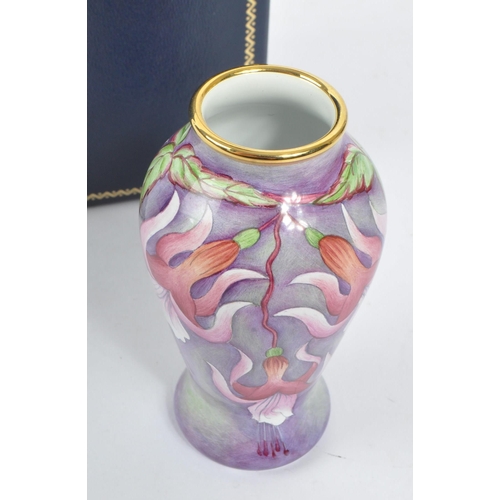 63 - Moorcroft Pottery - A contemporary small proportion vase. Fuchsia flowers with gilt rim. Signed and ... 