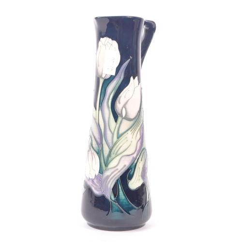 7 - Moorcroft - A china porcelain Moorcroft Pottery vase / jug in snow tulip pattern by Nicola Slaney. D... 