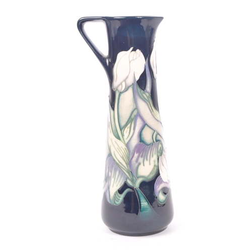 7 - Moorcroft - A china porcelain Moorcroft Pottery vase / jug in snow tulip pattern by Nicola Slaney. D... 