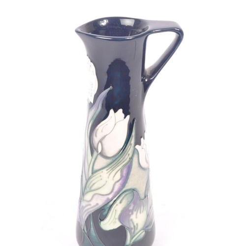 7 - Moorcroft - A china porcelain Moorcroft Pottery vase / jug in snow tulip pattern by Nicola Slaney. D... 