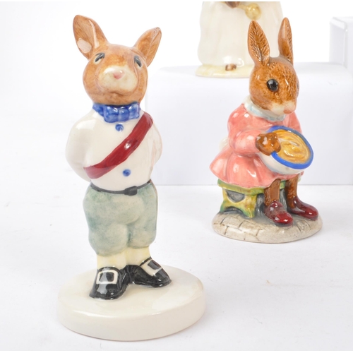 77 - Royal Doulton - Bunnykins - A collection of porcelain china bunny figurines / statues. Comprising of... 