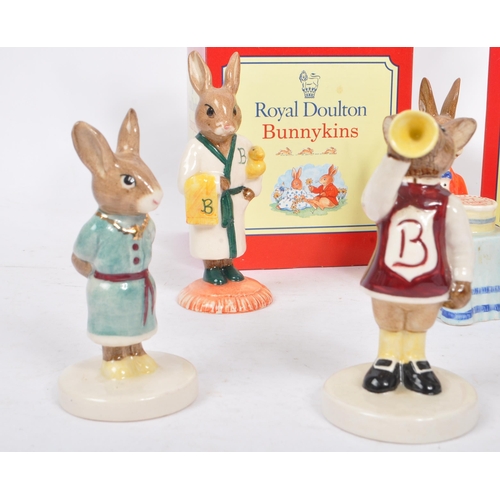 82 - Royal Doulton - Bunnykins - A collection of porcelain china figurines / statues. Comprising of bath ... 