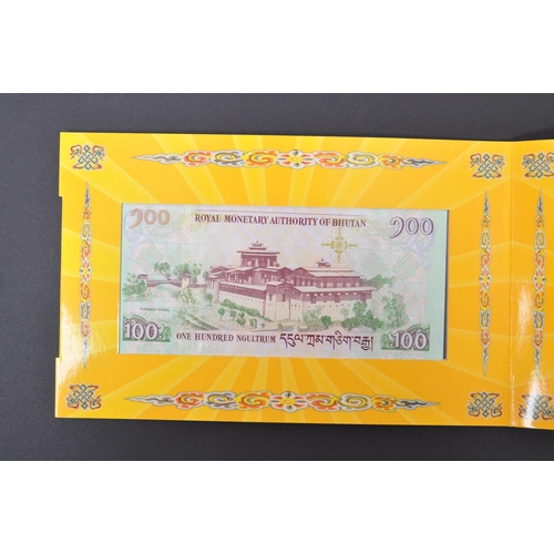 517 - A large collection of uncirculated international bank notes to include; Bhutan 2011 Royal Wedding 10... 